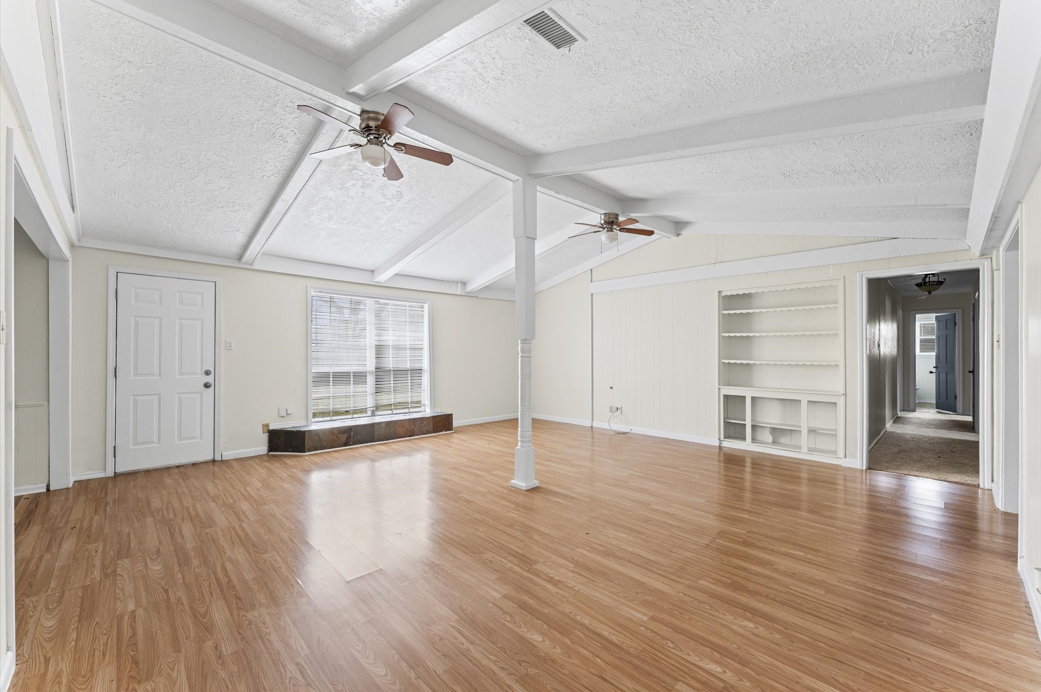 2709 Adams Street Alvin, TX 77511 - Photo 16 of 32 wooden floor in an empty room with a window