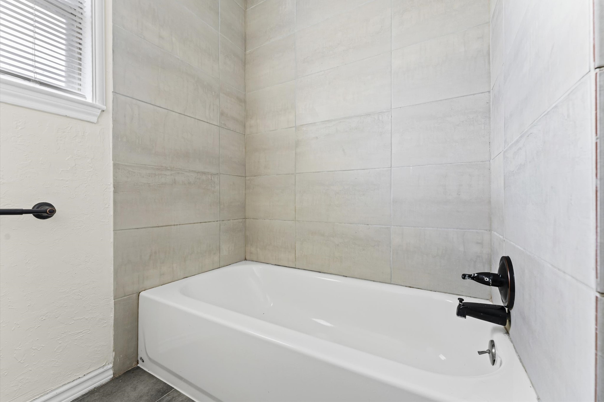 2709 Adams Street Alvin, TX 77511 - Photo 22 of 32 a bathroom with a white bath tub