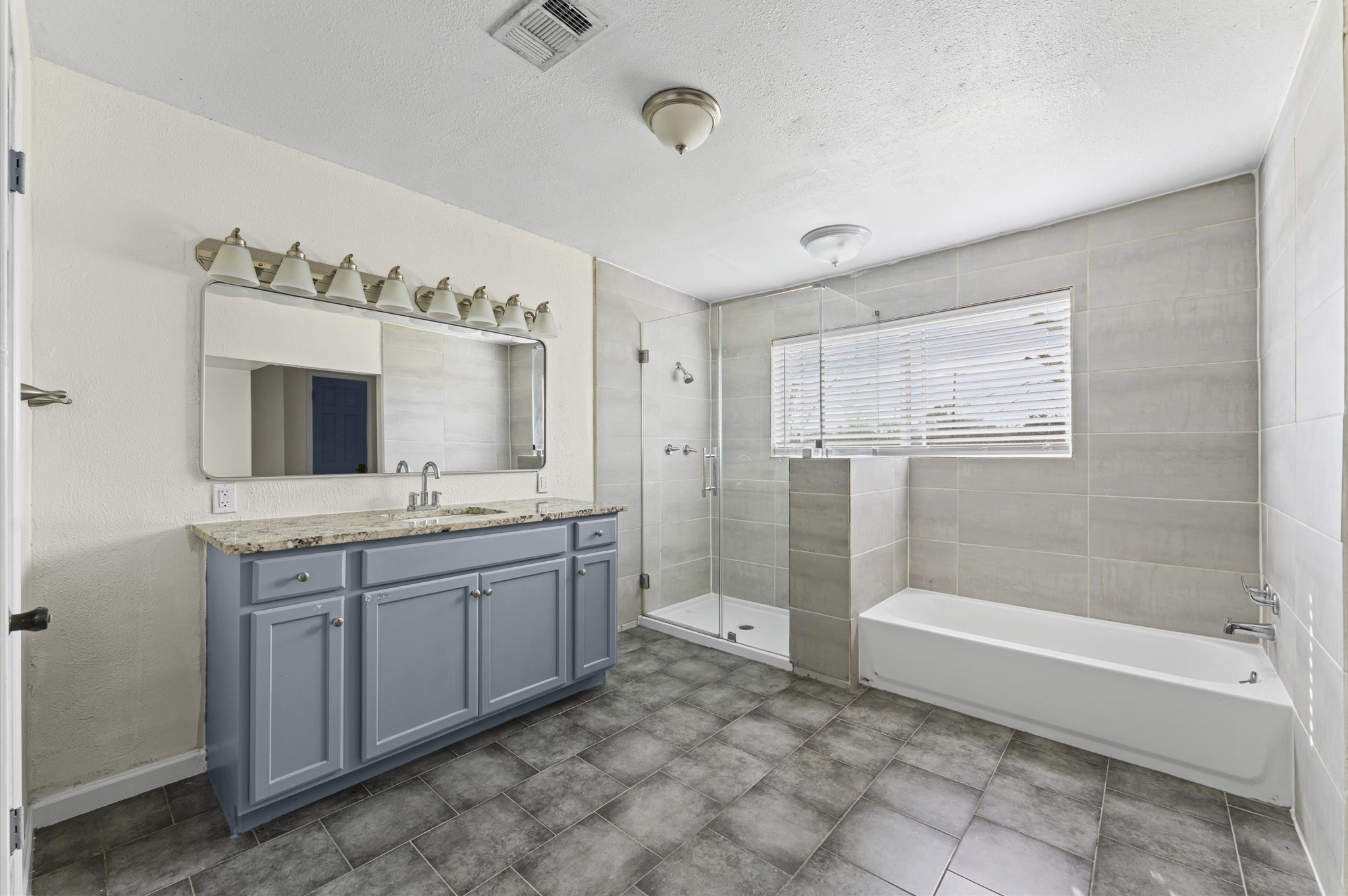 2709 Adams Street Alvin, TX 77511 - Photo 26 of 32 a bathroom with a tub sink and mirror