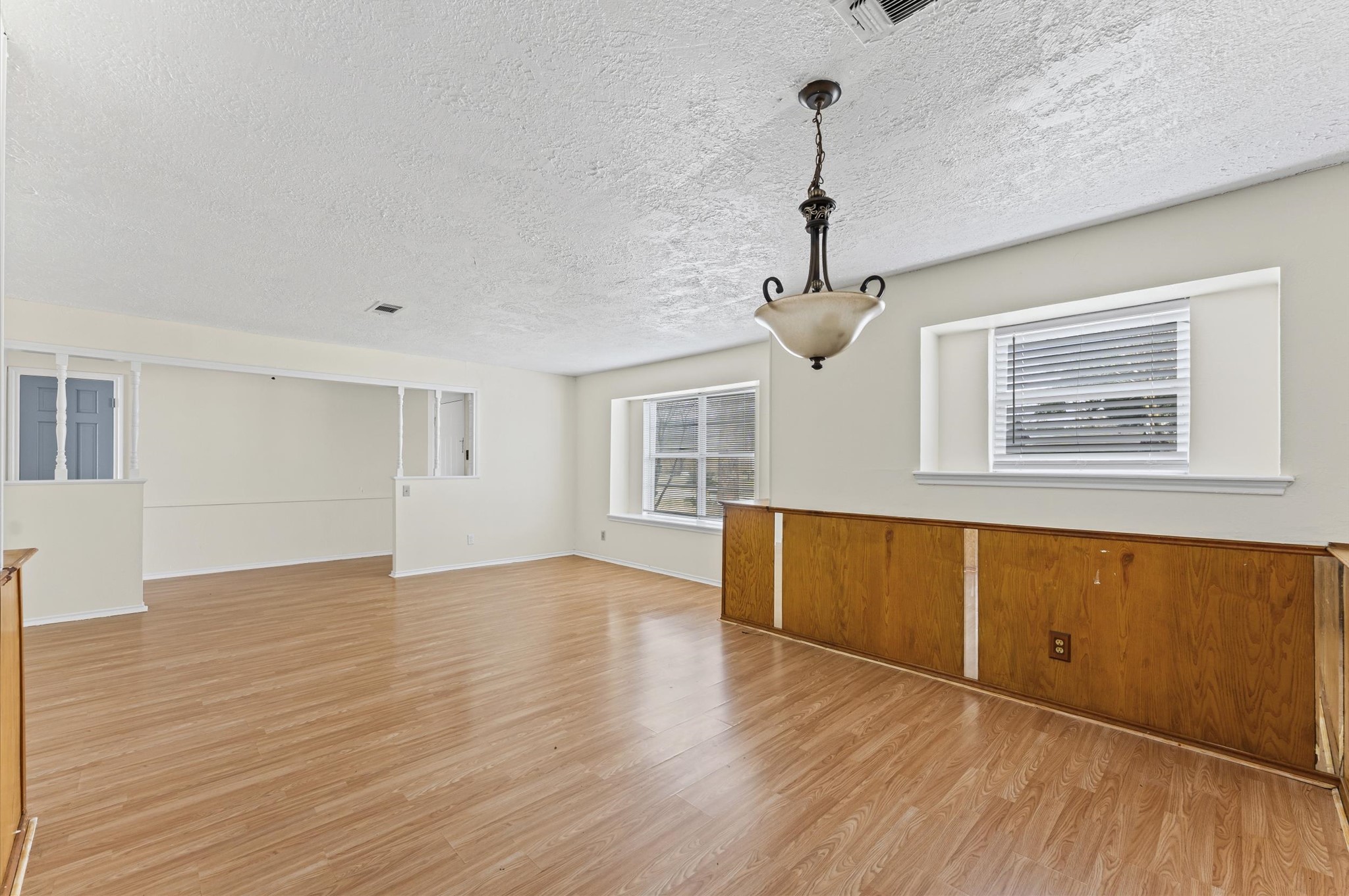2709 Adams Street Alvin, TX 77511 - Photo 7 of 32 a view of empty room with wooden floor and fan