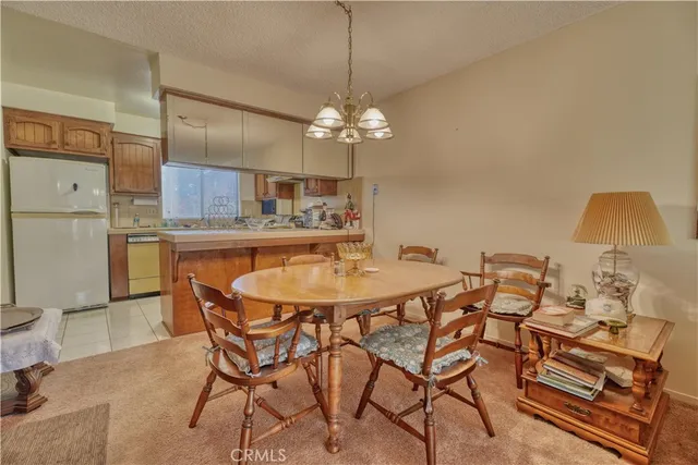 a view of a dining room with furniture and a chandelier