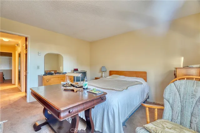 a view of a dining room with furniture and a chandelier