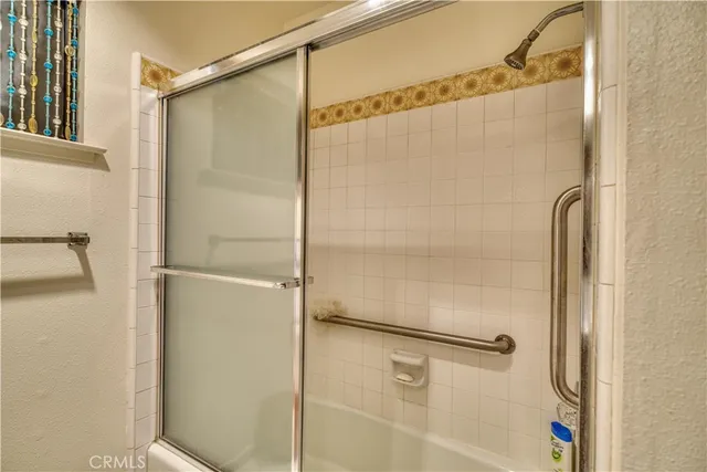 a bathroom with a glass shower door
