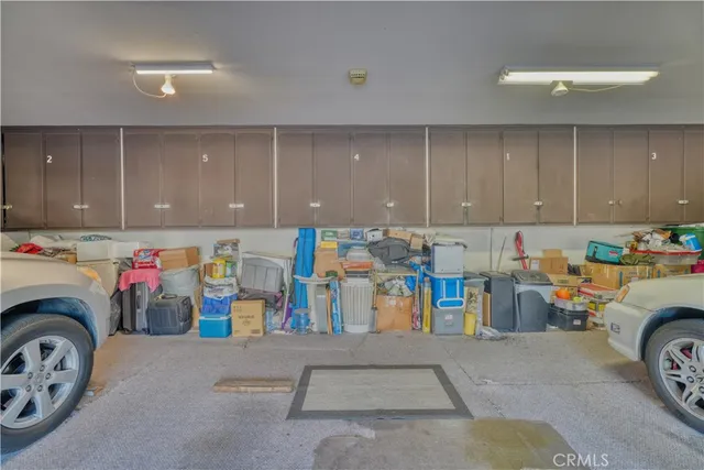 a view of storage and utility room with two washing machine