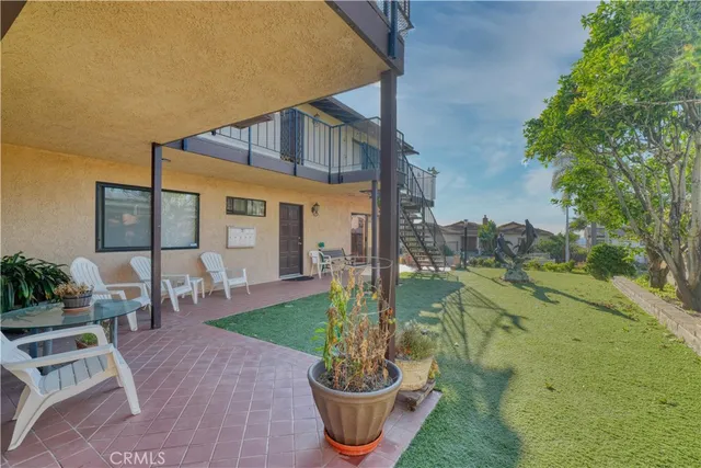 a front view of house with yard barbeque oven and outdoor seating