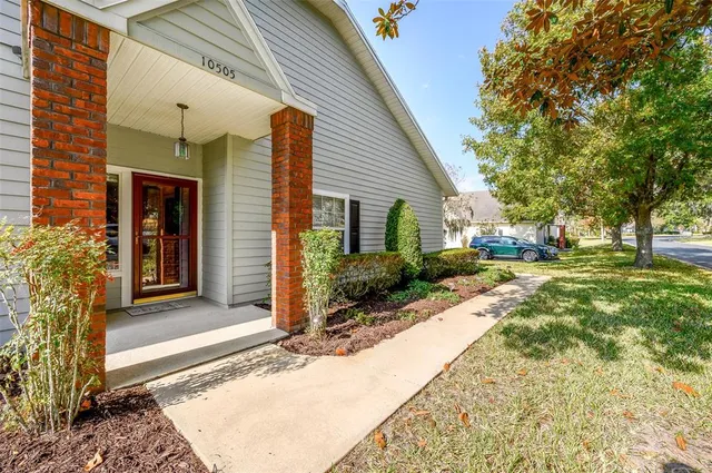 a view of a house with backyard and sitting area