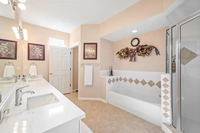 a bathroom with a bathtub sink and mirror