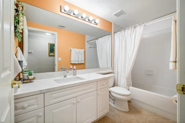 a bathroom with a sink a toilet and a large mirror