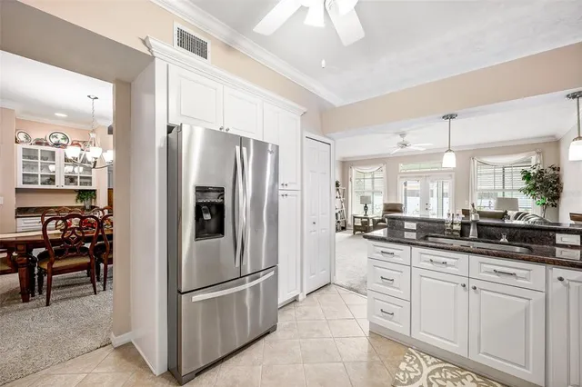 a kitchen with granite countertop a refrigerator and a sink
