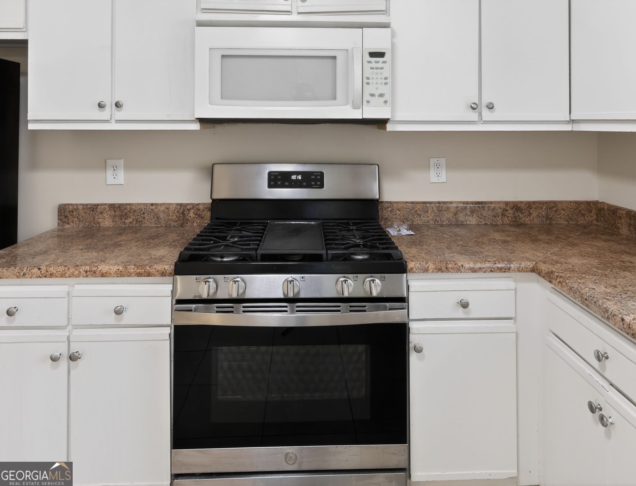 2492 Deep Shoals Circle Decatur, GA 30034 - Photo 11 of 31 a kitchen with granite countertop white cabinets and a stove