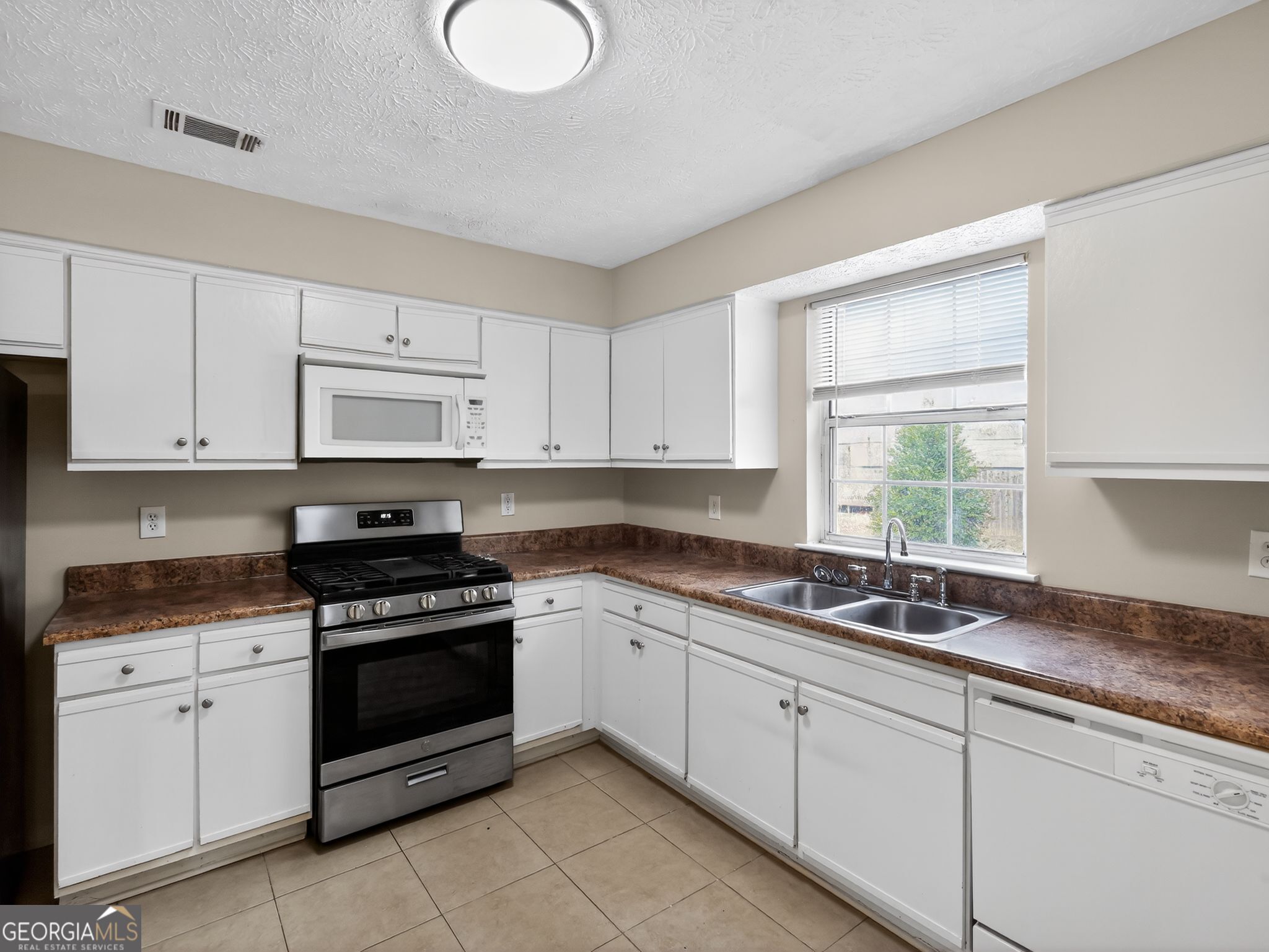 2492 Deep Shoals Circle Decatur, GA 30034 - Photo 12 of 31 a kitchen with granite countertop white cabinets white appliances and a sink