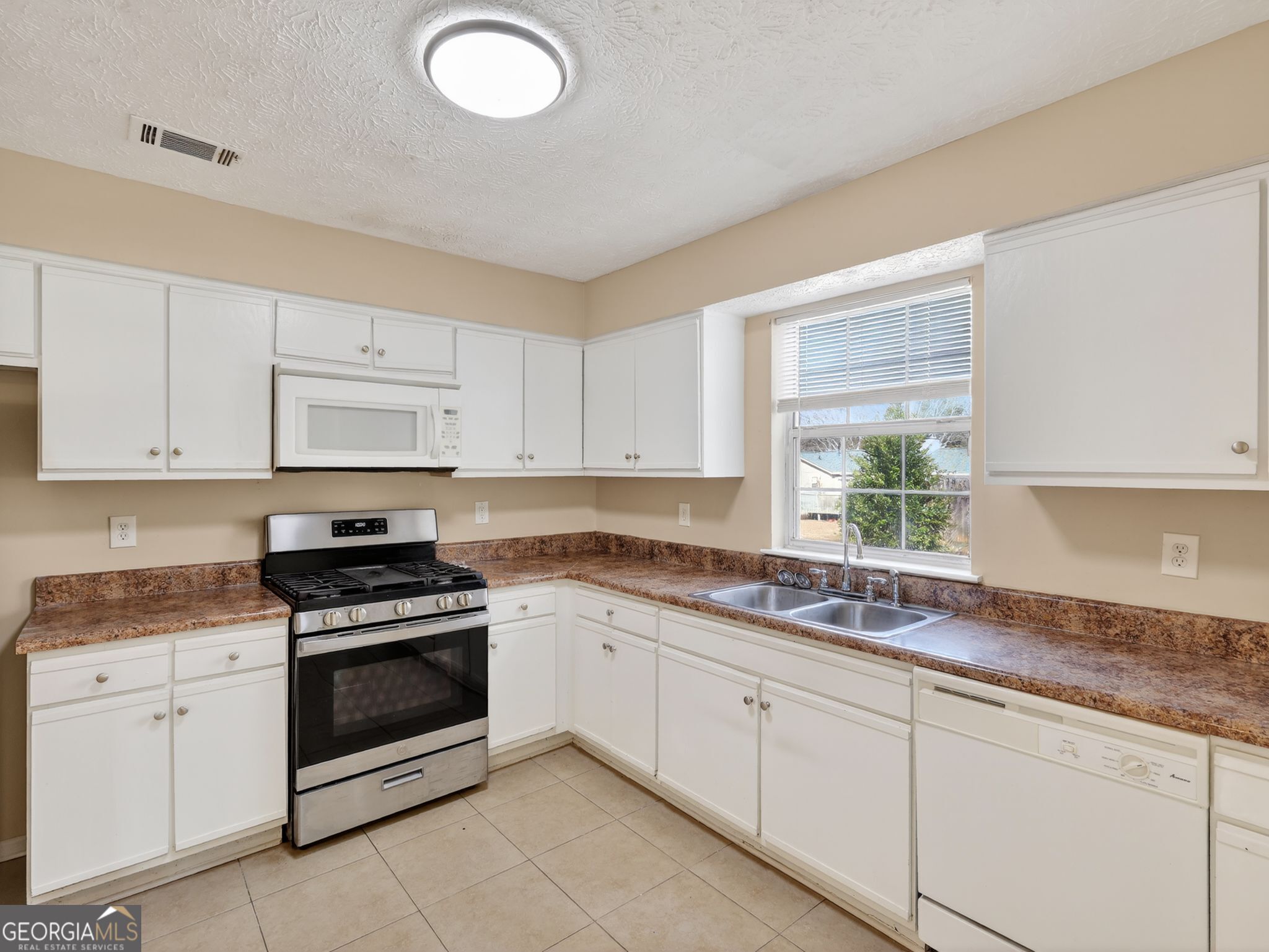2492 Deep Shoals Circle Decatur, GA 30034 - Photo 14 of 31 a kitchen with granite countertop white cabinets white stainless steel appliances and a sink