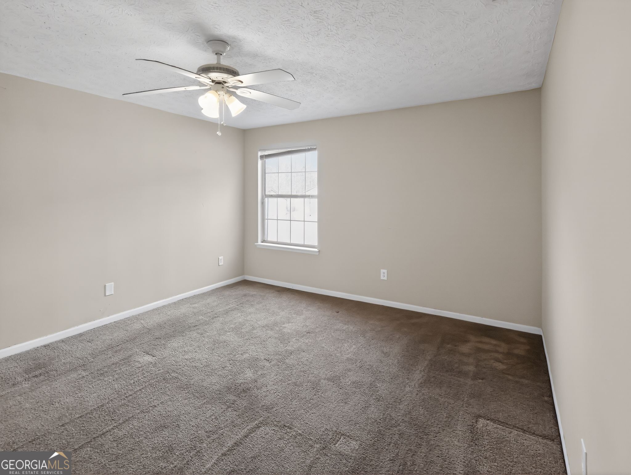 2492 Deep Shoals Circle Decatur, GA 30034 - Photo 18 of 31 an empty room with windows and chandelier fan