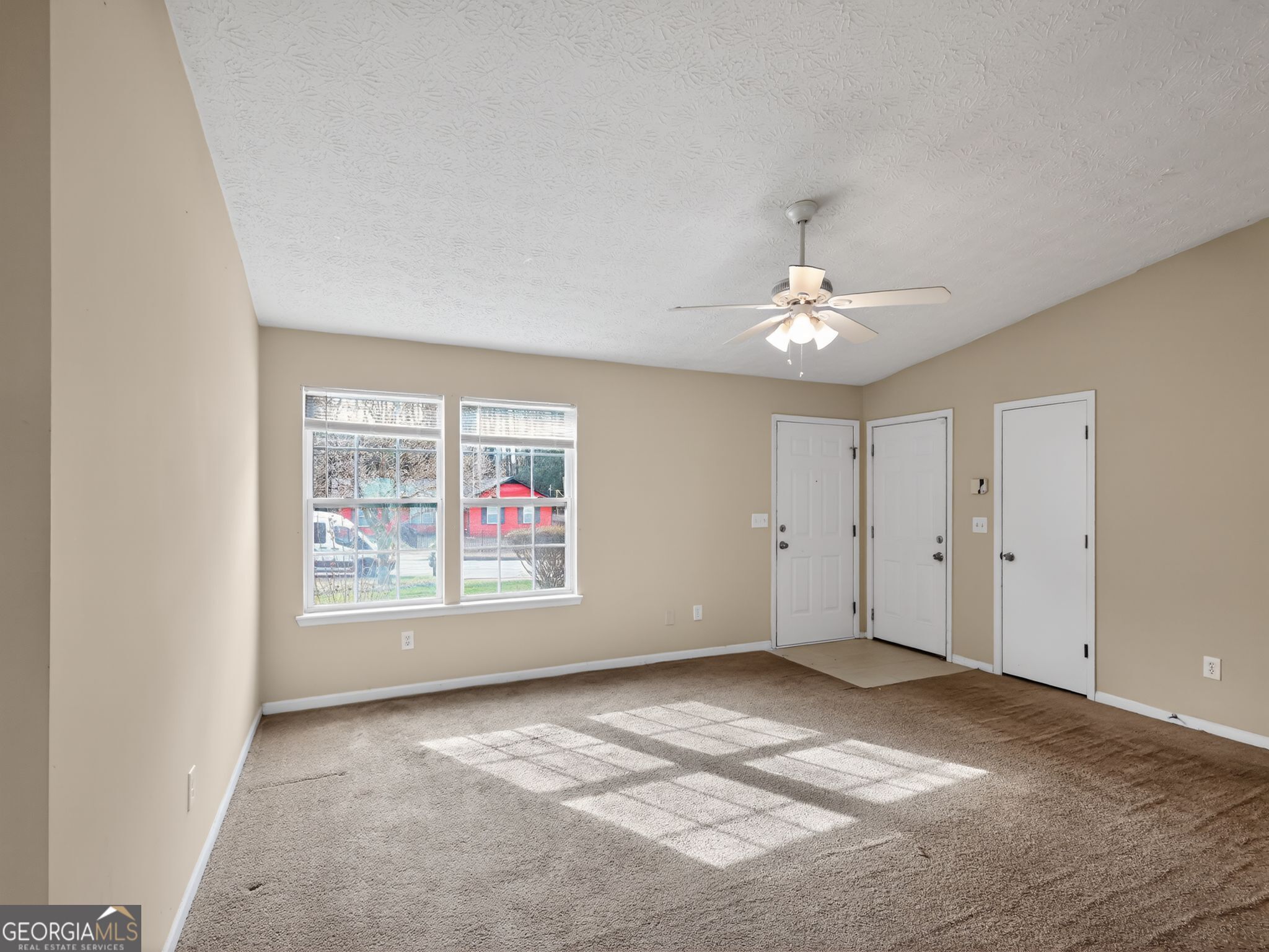 2492 Deep Shoals Circle Decatur, GA 30034 - Photo 4 of 31 an empty room with chandelier fan and windows