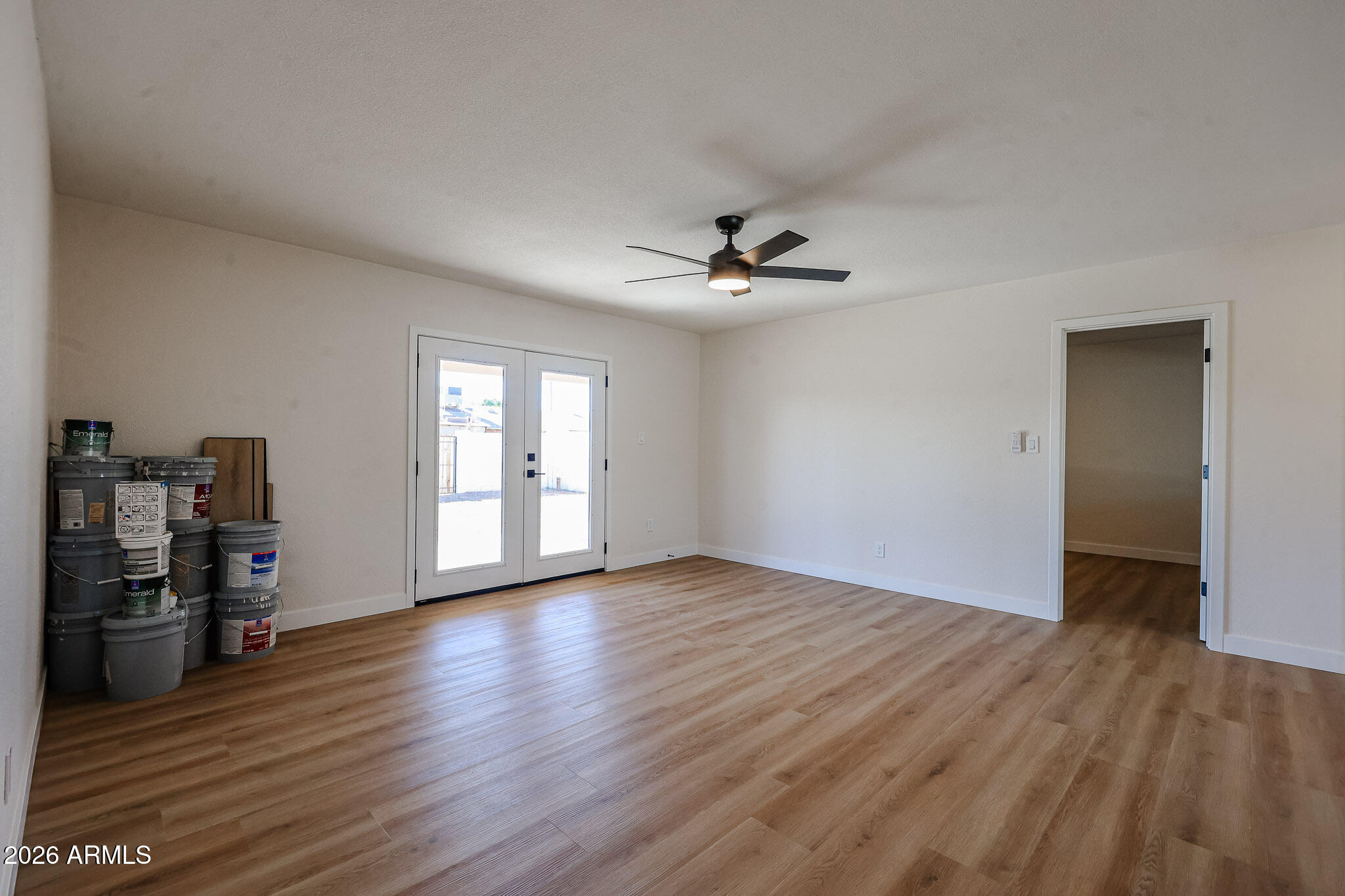 3337 West Ocotillo Road Phoenix, AZ 85017 - Photo 9 of 30 a view of an empty room with window and wooden floor