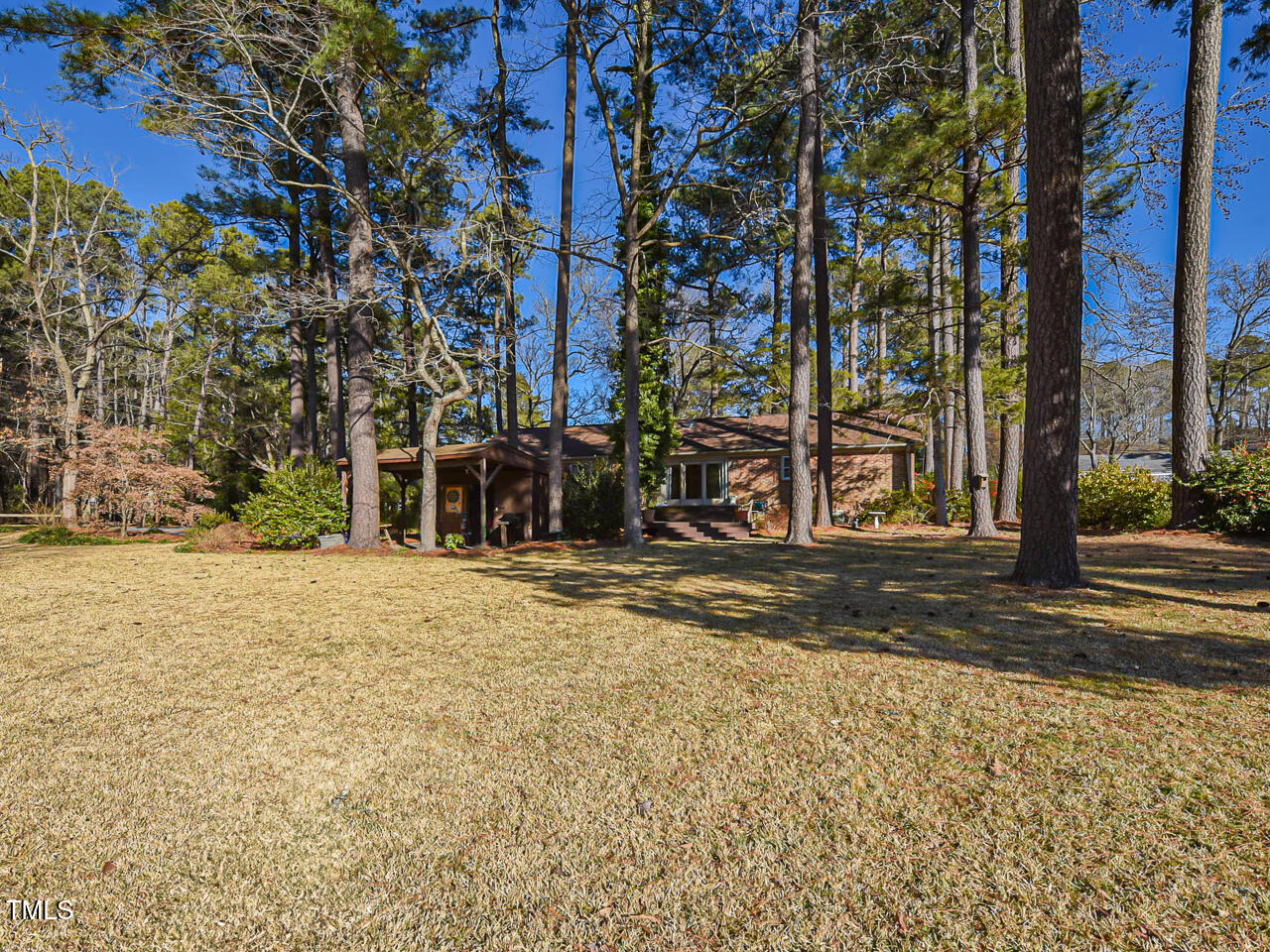 5200 Newhall Road Durham, NC 27713 - Photo 14 of 35 a street view with large trees