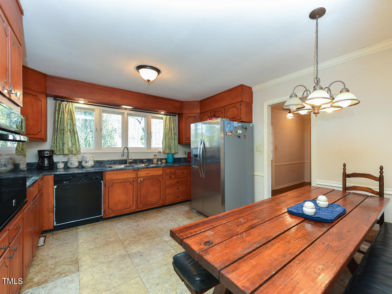 5200 Newhall Road Durham, NC 27713 - Photo 20 of 35 a kitchen with stainless steel appliances granite countertop a sink dishwasher and a wooden floor