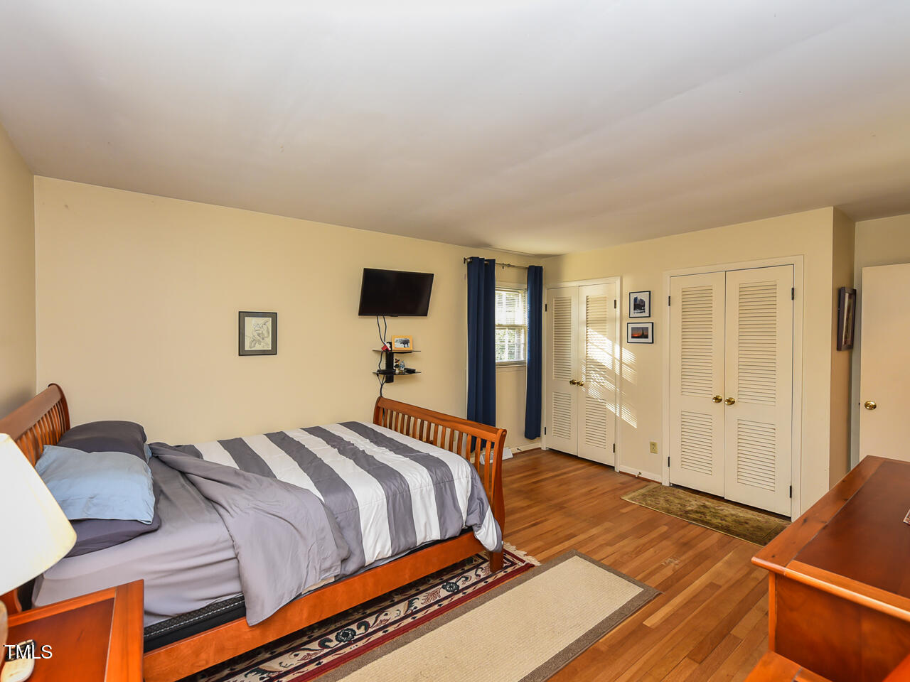 5200 Newhall Road Durham, NC 27713 - Photo 27 of 35 a bedroom with a bed and wooden floor