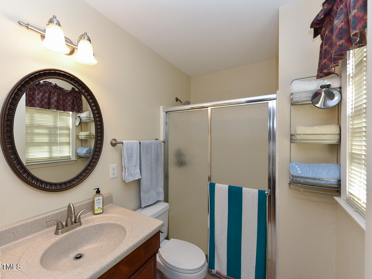 5200 Newhall Road Durham, NC 27713 - Photo 28 of 35 a bathroom with a sink and a mirror