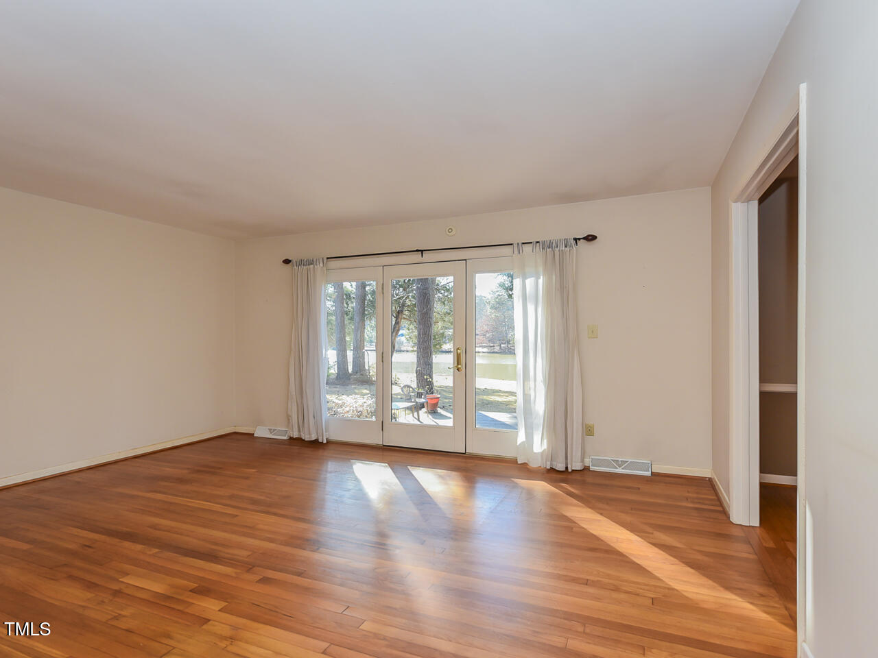 5200 Newhall Road Durham, NC 27713 - Photo 32 of 35 a view of an empty room with wooden floor and a window
