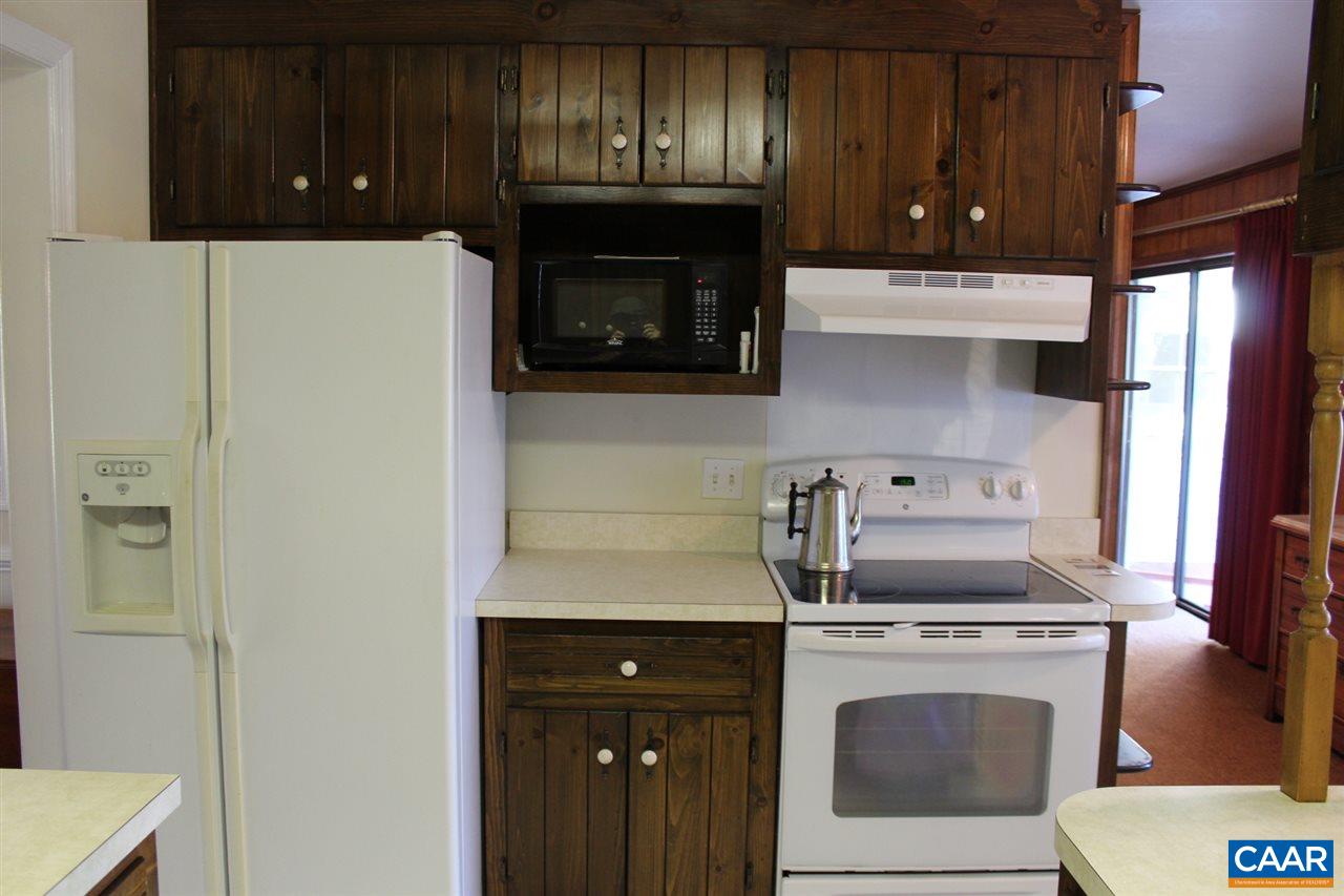 303 Evans Mill Road Dillwyn, VA 23936 - Photo 3 of 14 a kitchen with a stove and a microwave