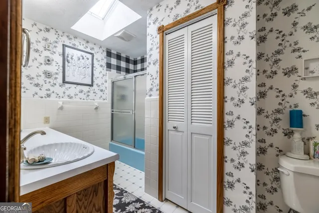 a room with lots of wooden furniture and a potted plant