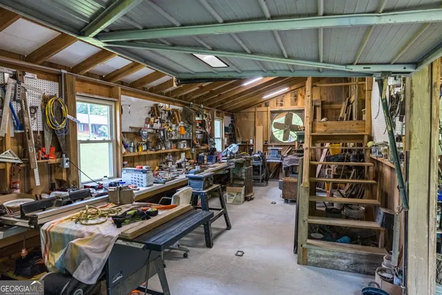 a view of a patio with a table and chairs under an umbrella