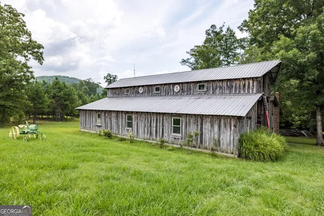a view of a house with wooden fence