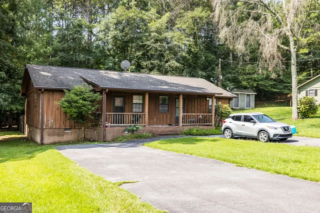 a view of a lush green forest with trees in the background