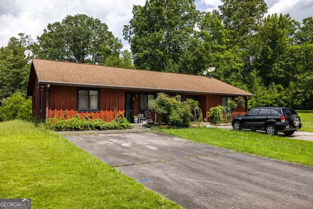 a backyard of a house with lots of green space and plants