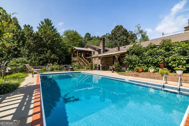 a dining room with furniture a chandelier and window