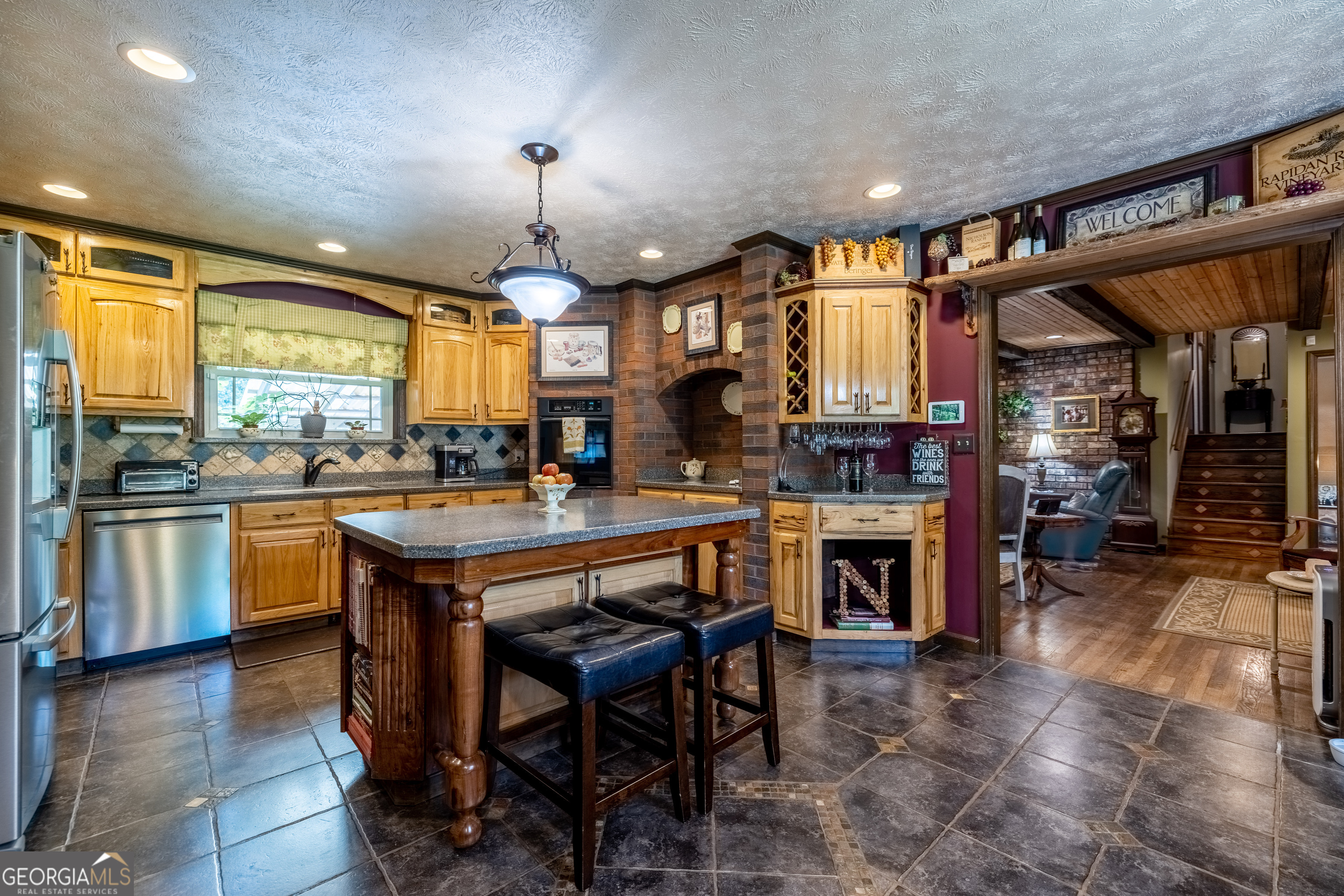 36 Stargazer Trail Northwest Rome, GA 30165 - Photo 6 of 79 a kitchen with stainless steel appliances granite countertop a stove a sink dishwasher a dining table and chairs a refrigerator with wooden cabinets
