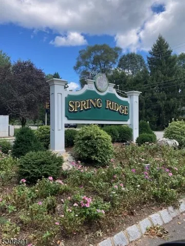 a sign that is sitting in front of flowers