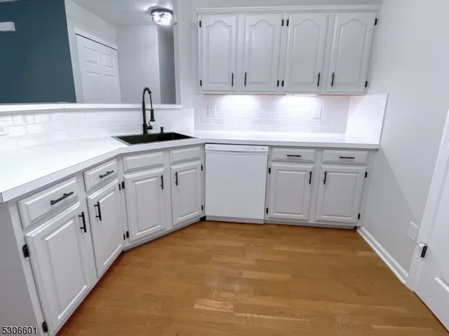 a kitchen with white cabinets