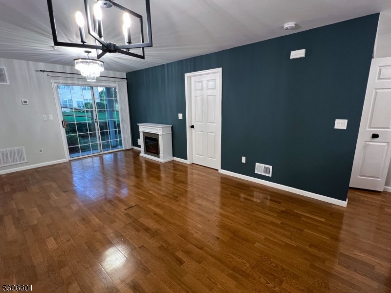 49 Potomac Drive Bernards, NJ 07920 - Photo 6 of 14 a view of an empty room with wooden floor and a window