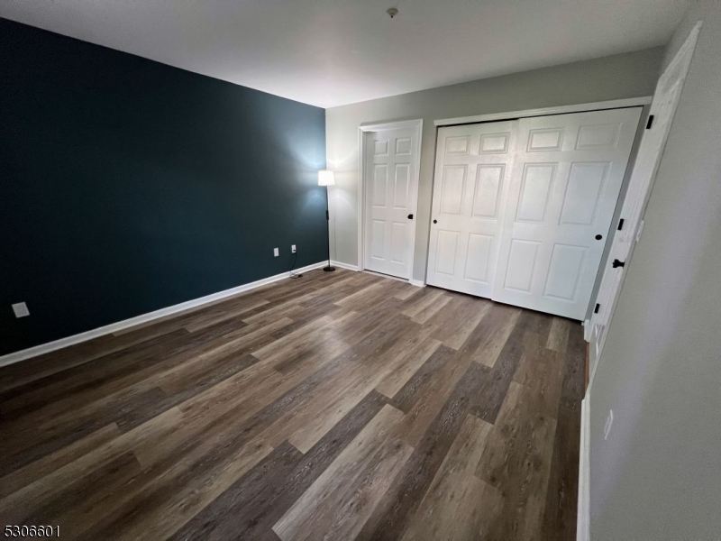49 Potomac Drive Bernards, NJ 07920 - Photo 8 of 14 a view of an empty room with wooden floor and a window
