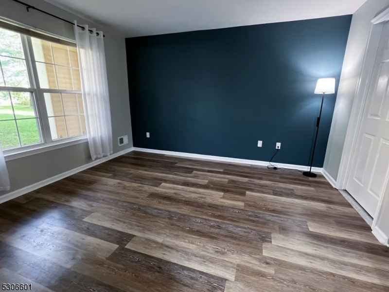 49 Potomac Drive Bernards, NJ 07920 - Photo 9 of 14 an empty room with wooden floor and windows