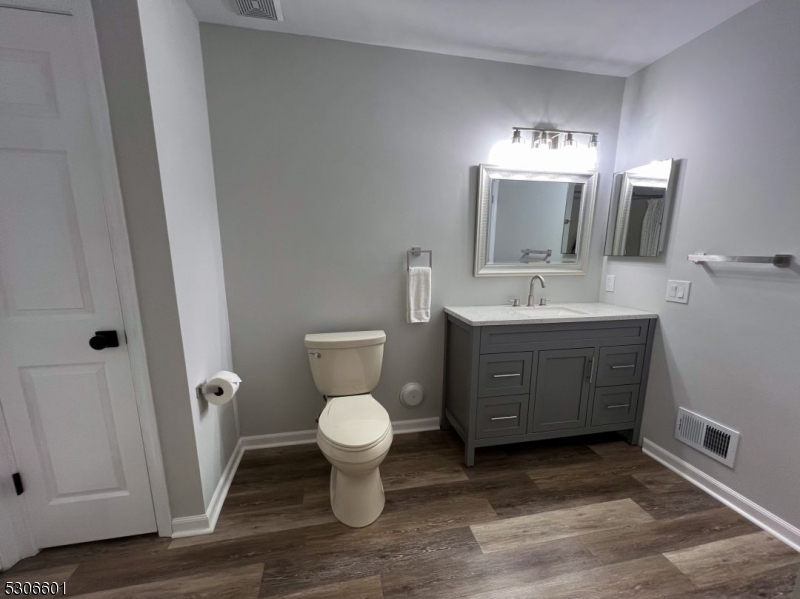 49 Potomac Drive Bernards, NJ 07920 - Photo 10 of 14 a spacious bathroom with a toilet sink and mirror