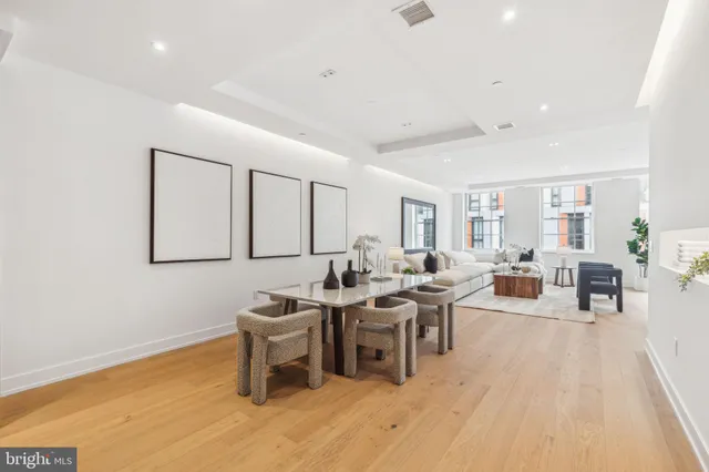 a living room with furniture a rug and a table
