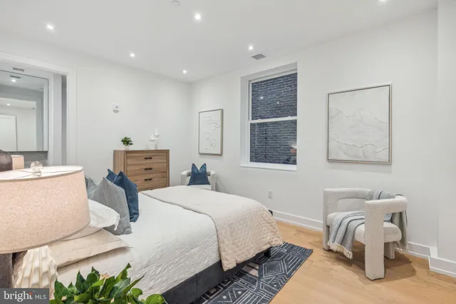 a bedroom with a bed and a chair