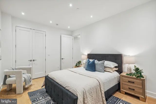 a bedroom with a bed and a potted plant