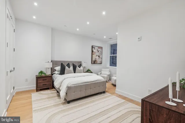 a spacious bedroom with a bed and a couch