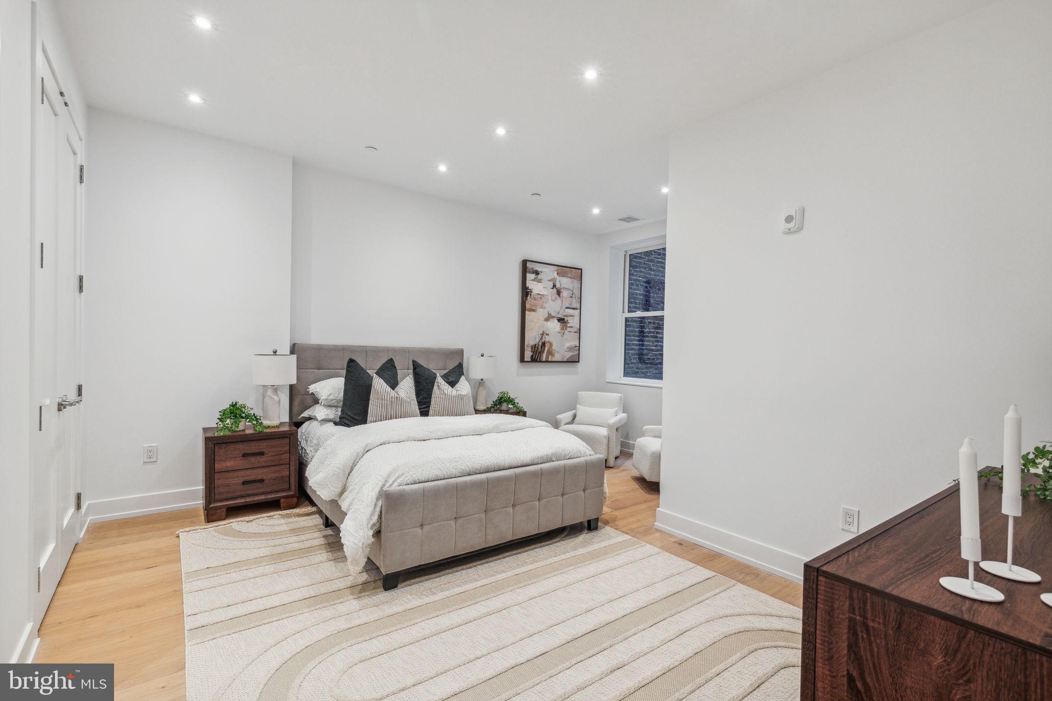 124 North 2nd Street, Unit 4 Philadelphia, PA 19106 - Photo 27 of 48 a spacious bedroom with a bed and a couch