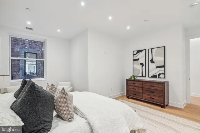 a bedroom with a bed and a dresser