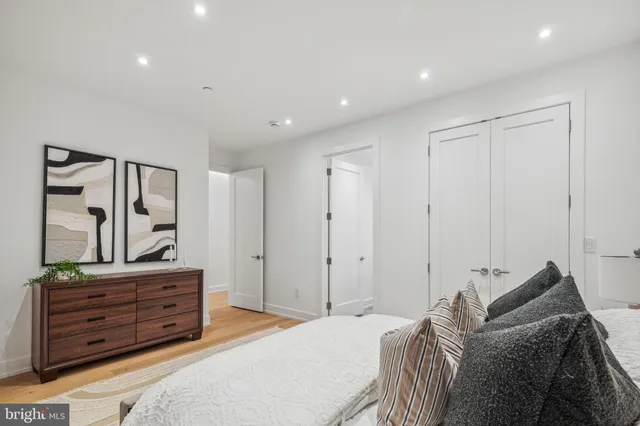 a bedroom with a bed and a mirror