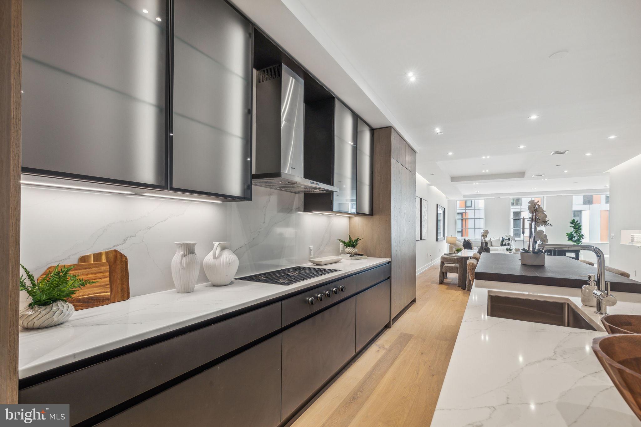 124 North 2nd Street, Unit 4 Philadelphia, PA 19106 - Photo 3 of 48 a kitchen with stainless steel appliances kitchen island granite countertop a sink and cabinets