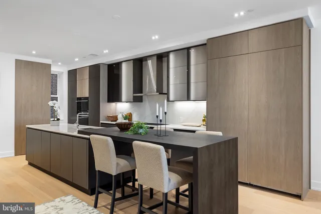 a kitchen with stainless steel appliances granite countertop a sink and a refrigerator