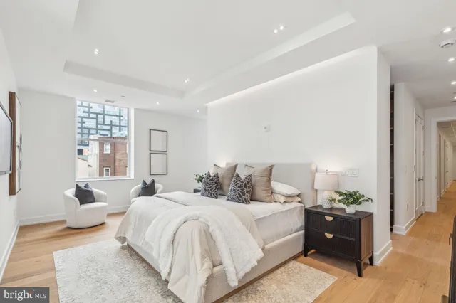 a spacious bedroom with a bed and a couch