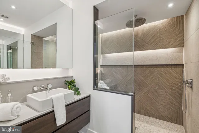 a bathroom with a tub sink and mirror