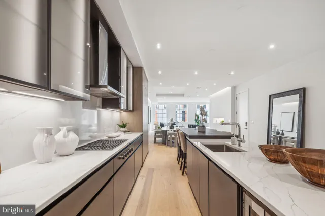 a kitchen with counter top space a sink and appliances